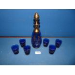 A cobalt blue and gilt continental glass decanter and six matching glasses with Venetian scenes,