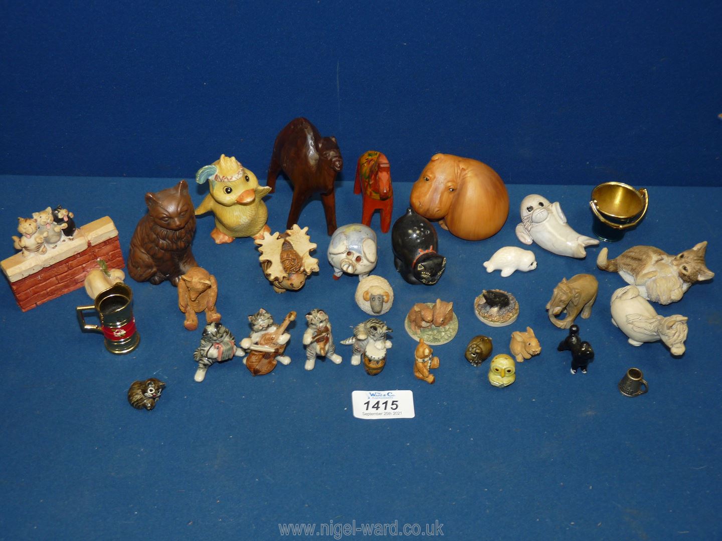 A quantity of animal figures including seal, cow and horse, hippo, cat band, pig, rabbits, mole,