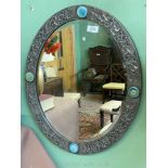 An oval Pewter bevelled glass wall Mirror,