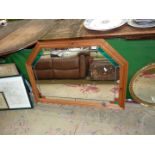 A six sided mirror with green and orange stained glass to corners, 41" wide x 29" tall.