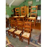 A set of six contemporary Oak framed ladder-back dining chairs having sea-grass seats.