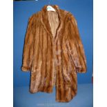 A three quarter length fur coat with side pockets in two tone brown, size M,
