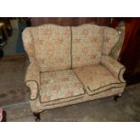 A pre 1950 Georgian design two seater Sofa having winged back and standing on brief Mahogany