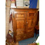 An unusual Pine Armoire/Cupboard having opposing panelled doors with iron 'H' hinges and tear-drop