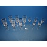 Six cut glass flutes and five sherry glasses.