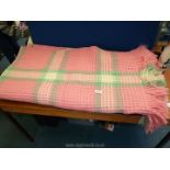 A pink and cream double waffle blanket. Approx 84" x 84".