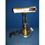 A brass finish banker's lamp.