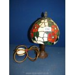 A small Tiffany style lamp, the glass shade decorated with red flowers and green foliage,