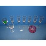 Six champagne flutes with blue spiral stems and cranberry glass bowl,
