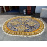 An oval, bordered, patterned and fringed Rug with geometric lozenge panels to centre, in orange,