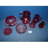 A box of assorted Cranberry glass to include jugs, dishes etc.