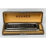 A boxed Chromonika III M. Hohner harmonica.