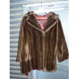 A 3/4 length fur coat with button fastening by Tissaval, 100% acrylic.