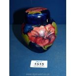 A Moorcroft Hibiscus ginger jar, paper label to lid and underneath jar, lid a/f, 4 1/2" tall.