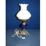 An oil lamp converted to electric with metal base,