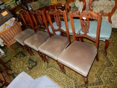 A set of four Edwardian Mahogany dining Chairs having extremely delicate fretworked and carved