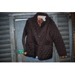 A ladies quilted Barbour Jacket, chocolate brown with floral lining, size 16.