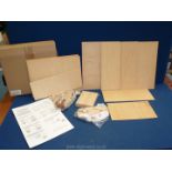 Two boxed wooden assembly kits one of wagon wheels and the other a stage coach.