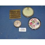 Four compacts, some enamelled, some decorated with flowers etc.