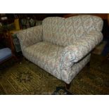 An Edwardian single drop end two seater Settee nicely upholstered in cream ground stylised floral