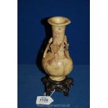A Chinese hand carved soapstone Vase with floral decoration and carved five footed base,