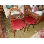 A pair of Mahogany framed circa 1900 side chairs with oval back-rests featuring nicely carved swags