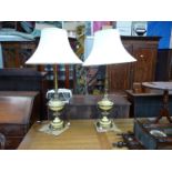 A pair of tall yellow and brass Art Deco style Lamps having petal decoration and a pair of large