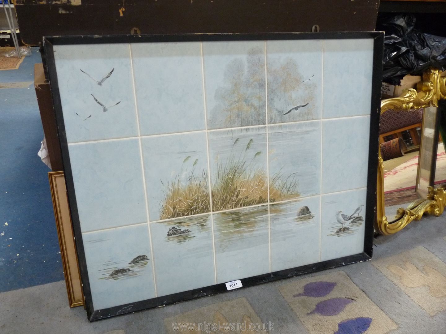 A set of framed tiles depicting seagulls, etc.