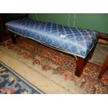 An unusual low stool/window seat standing on moulded square legs with fret-worked brackets and