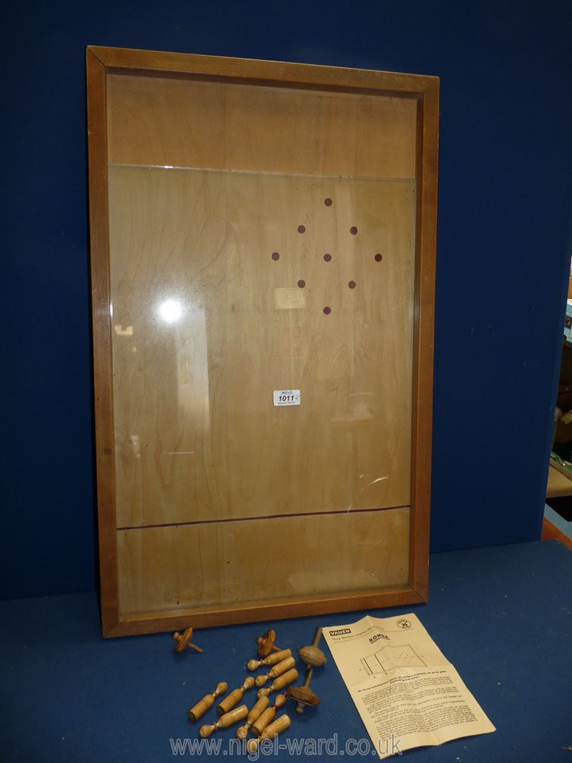 A Pinball game in glass case with pieces.