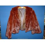 A short waisted rich red fur coat, minor pelt seam split to one side, repairable.