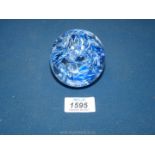 A marbled paperweight with blue ribbon effect.