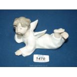 A Lladro figure of an Angel boy laying down. 6" long.