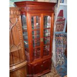 A contemporary red Mahogany canted corner Display Cabinet over cupboard having arched bevelled