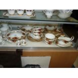 A Royal Albert Country Roses dinner service to include two lidded tureens, six sweet plates,