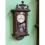 An Edwardian musical wall clock having Roman numerals, with key and pendulum, a/f.