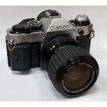 A Canon AE-1 Program 35mm SLR camera with a Sigma Zoom-Master 35-70mm f/2.