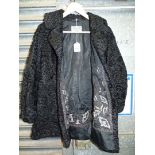 A vintage 1960's classic black curly lambs fur Coat/jacket with embroidered detail to lining by