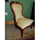 A contemporary dark-wood show-frame buttoned-back chair upholstered in cream Dralon.