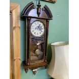 A large two train movement wall clock with Roman numerals with pendulum and key, 45" tall face a/f.
