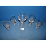 Five old drinking glasses with footed stems, all various sizes.