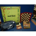 A B.O.A.C flight bag, plus boxed Chess pieces, Draughts, Monopoly board, etc.