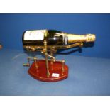 A hand crafted solid brass mechanical wine decanting cradle having a beautifully hand made solid