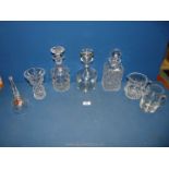 A small quantity of glass including; three decanters (two cut glass), cream jug, engraved tankard,