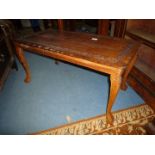 An oriental hardwood rectangular Coffee Table having a trailing foliage frieze to the top,