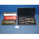 A black cased drawing set together with a cased Parker fountain pen, and two cased Parker biros.