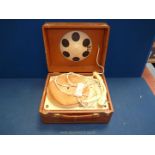 A Barbier bakelite record player in brown carrying case.