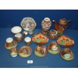 An oriental Teaset in brown, orange and green including teapot, six cups, five saucers, two plates,