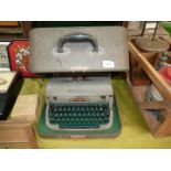 A cased Remington typewriter, grey in a brown case.