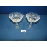 Two Waterford crystal cut champagne glasses; one with original sticker on.